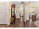 Welcoming hallway showcasing hardwood floors, a staircase, and views to living spaces at 547 Pontoon Rd, Huger, SC 29450