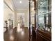 Elegant hallway with hardwood floors, a display cabinet, and views to the dining and kitchen areas at 547 Pontoon Rd, Huger, SC 29450