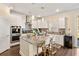 Open-concept kitchen with a granite island, pendant lighting, and stainless steel appliances at 547 Pontoon Rd, Huger, SC 29450