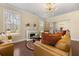 Cozy living room featuring a fireplace, modern lighting fixture, and hardwood floors at 547 Pontoon Rd, Huger, SC 29450