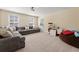 Large living room with natural light, plush gray seating, and a TV area at 547 Pontoon Rd, Huger, SC 29450