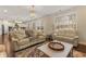 Elegant living room with a crystal chandelier, hardwood floors, and a view to the dining area at 547 Pontoon Rd, Huger, SC 29450