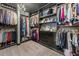 A walk-in closet featuring custom shelving, hanging racks, and a stylish chandelier at 547 Pontoon Rd, Huger, SC 29450