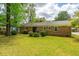 Charming brick home with a spacious backyard, including a patio area and well-kept landscaping at 6018 Ridgecrest Ave, Hanahan, SC 29410