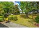 Cozy backyard deck with a comfortable hanging chair, surrounded by green grass and lush foliage at 6018 Ridgecrest Ave, Hanahan, SC 29410