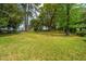 Spacious backyard showcasing lush greenery, mature trees, and ample space for outdoor activities at 6018 Ridgecrest Ave, Hanahan, SC 29410