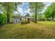 Expansive backyard with mature trees, a storage shed, and lush lawn, perfect for outdoor enjoyment at 6018 Ridgecrest Ave, Hanahan, SC 29410