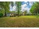 View of the backyard, with the back of the house and adjacent houses visible at 6018 Ridgecrest Ave, Hanahan, SC 29410