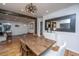 Open-concept dining area with modern table and decor, with hardwood floors and unique lighting fixture at 6018 Ridgecrest Ave, Hanahan, SC 29410