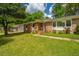 Charming brick home with a well-manicured lawn and flowering shrubs, offering classic curb appeal at 6018 Ridgecrest Ave, Hanahan, SC 29410