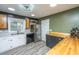 Well-lit kitchen offers white cabinets, stainless steel appliances, and a butcher block countertop at 6018 Ridgecrest Ave, Hanahan, SC 29410
