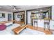 Bright living room with wooden accent beams, hardwood floors, and an open view of the modern kitchen at 6018 Ridgecrest Ave, Hanahan, SC 29410