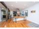 Spacious living room with hardwood floors, exposed beams, a fireplace, and large windows for natural light at 6018 Ridgecrest Ave, Hanahan, SC 29410
