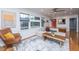 Cozy living room with hardwood floors, a comfortable couch, and large windows create a welcoming atmosphere at 6018 Ridgecrest Ave, Hanahan, SC 29410