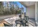 Covered back porch with a charming metal table set perfect for outdoor relaxation and grilling at 614 Beach Way, Summerville, SC 29486