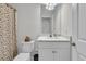 Bright bathroom boasts a marble countertop, framed mirror, and patterned shower curtain at 614 Beach Way, Summerville, SC 29486