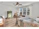 Cozy bedroom featuring hardwood floors, a ceiling fan, and a comfortable seating area at 614 Beach Way, Summerville, SC 29486