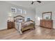 Bedroom with hardwood floors, large windows, and a decorative dresser at 614 Beach Way, Summerville, SC 29486