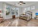 Bright bedroom with hardwood floors, large windows, and a cozy seating area at 614 Beach Way, Summerville, SC 29486