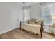 Bright bedroom features a cozy daybed, white trim, and natural light from two windows at 614 Beach Way, Summerville, SC 29486