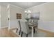 A cozy dining room featuring a modern chandelier, wainscoting, and comfortable seating at 614 Beach Way, Summerville, SC 29486