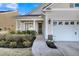 Inviting home showcasing manicured landscaping, an accent trimmed two-car garage, and a charming entryway at 614 Beach Way, Summerville, SC 29486