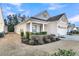 Beautiful home boasting manicured landscaping and a two-car garage, complemented by a well-maintained lawn at 614 Beach Way, Summerville, SC 29486