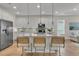 Modern kitchen with stainless appliances, a large island with bar stools, and pendant lighting at 614 Beach Way, Summerville, SC 29486