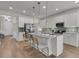 Modern kitchen with stainless steel appliances, island with seating, and sleek cabinetry at 614 Beach Way, Summerville, SC 29486