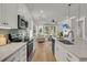 Open kitchen with stainless steel appliances and views into the living room and fireplace at 614 Beach Way, Summerville, SC 29486