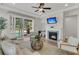 Inviting living room with fireplace, ceiling fan, and sliding doors opening to the outdoors at 614 Beach Way, Summerville, SC 29486