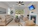 Bright living room features stylish seating, a fireplace, and a view to the backyard at 614 Beach Way, Summerville, SC 29486