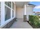 Cozy covered front porch with stone pillar accents offering tranquil outdoor ambiance and ample privacy with lush green foliage at 614 Beach Way, Summerville, SC 29486