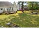 Large backyard with a deck, garden, mature trees, and outdoor seating around a fire pit at 68 Oyster Point Row, Charleston, SC 29412