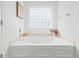 Bright bathroom featuring a large soaking tub and window at 68 Oyster Point Row, Charleston, SC 29412