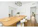 Open concept dining room featuring light-colored wood floors, a modern light fixture, and lots of windows at 68 Oyster Point Row, Charleston, SC 29412