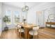 Light-filled dining room featuring light-colored wood floors, a modern light fixture, and ample windows at 68 Oyster Point Row, Charleston, SC 29412