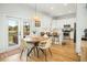 Eat-in kitchen features stainless appliances, white cabinets, and natural light from French doors at 68 Oyster Point Row, Charleston, SC 29412