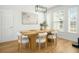 Bright dining area featuring hardwood floors, a modern light fixture, and ample windows at 68 Oyster Point Row, Charleston, SC 29412
