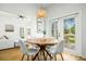 Bright dining area with a round table, French doors, and view into the living room at 68 Oyster Point Row, Charleston, SC 29412