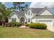 Beautiful two-story home with lush landscaping and a well-kept front lawn in a suburban neighborhood at 68 Oyster Point Row, Charleston, SC 29412