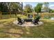 Relaxing outdoor fire pit area with Adirondack chairs, gravel, and views of a backyard pond at 68 Oyster Point Row, Charleston, SC 29412