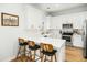 This kitchen boasts ample white cabinetry, quartz countertops, and stainless steel appliances at 68 Oyster Point Row, Charleston, SC 29412