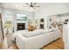 Open concept living room with fireplace, large windows, and hardwood flooring at 68 Oyster Point Row, Charleston, SC 29412