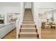 Carpeted staircase leading to the second floor with views of the living room and dining room at 68 Oyster Point Row, Charleston, SC 29412