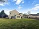 Large backyard with lush green grass and a full wooden fence at 7483 Hawks Cir, Hanahan, SC 29410