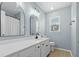 Stylish bathroom featuring double sinks, sleek mirrors, modern lighting, and updated fixtures at 7483 Hawks Cir, Hanahan, SC 29410