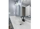 A close-up shot of a white vanity with black fixtures in a bathroom at 7483 Hawks Cir, Hanahan, SC 29410