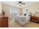 Comfortable bedroom with a large window, ceiling fan, carpet and a plush upholstered headboard at 7483 Hawks Cir, Hanahan, SC 29410