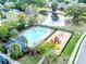 Aerial view of a neighborhood pool and playground surrounded by lush greenery at 7483 Hawks Cir, Hanahan, SC 29410
